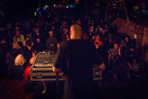 Dhangsha in a live performance seen from behind wiht crowd ahead